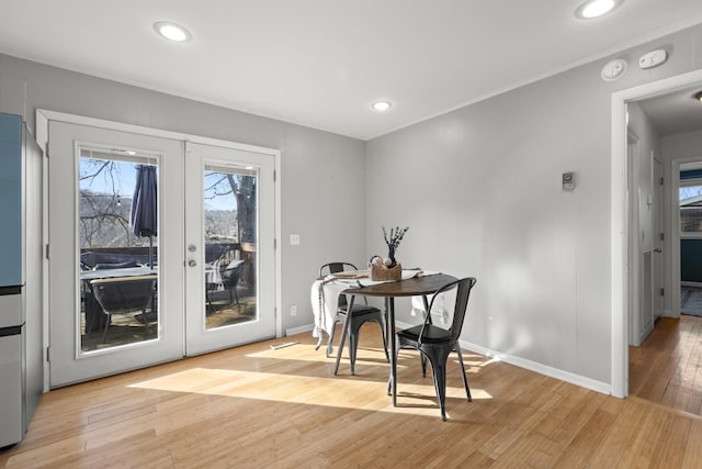 dining space featuring french doors, recessed lighting, light wood-style floors, ornamental molding, and baseboards