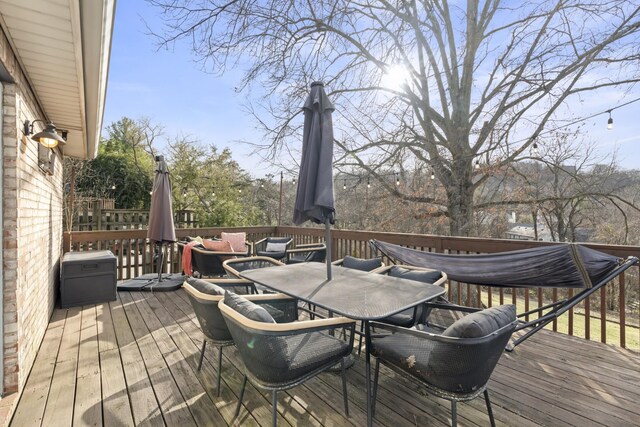 wooden terrace with outdoor dining area