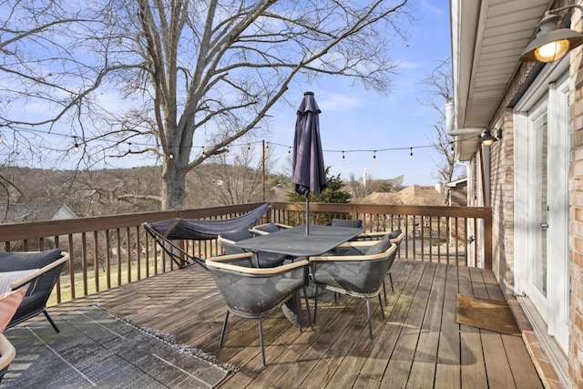 wooden deck featuring outdoor dining area