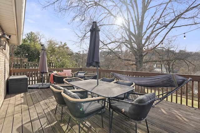 wooden terrace with outdoor dining space