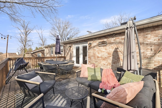 deck featuring outdoor lounge area, french doors, and outdoor dining space