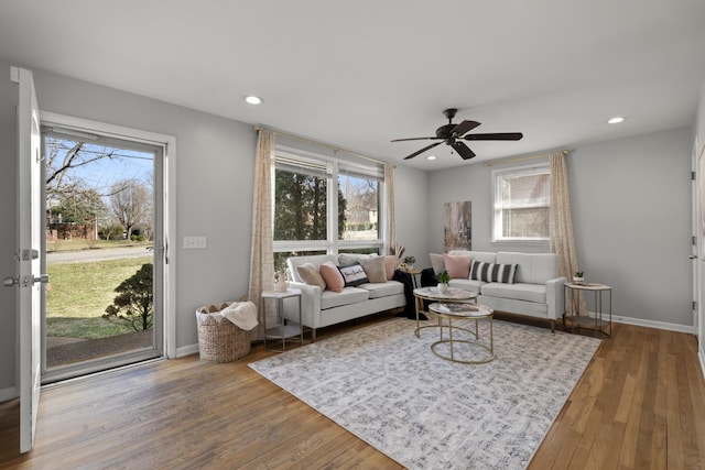 living area with baseboards, wood finished floors, a ceiling fan, and recessed lighting