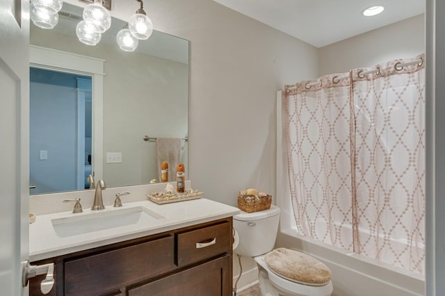 full bathroom featuring shower / bath combo, vanity, and toilet