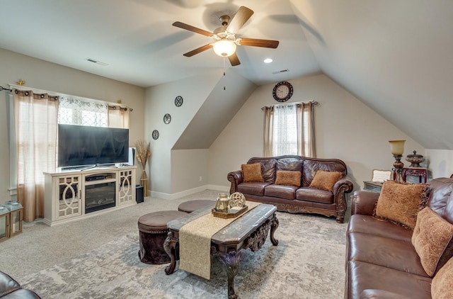 living room featuring lofted ceiling, carpet flooring, a ceiling fan, visible vents, and baseboards