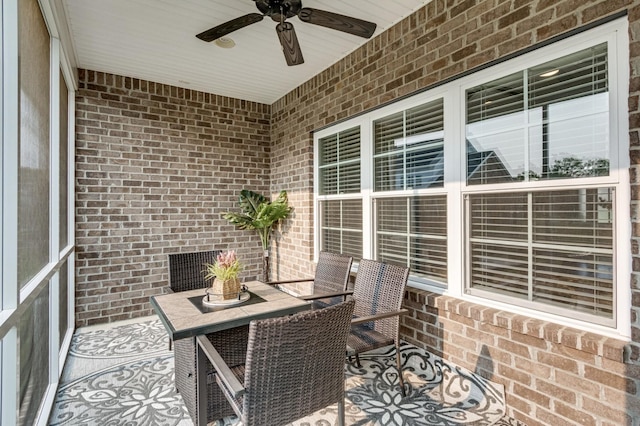 sunroom featuring ceiling fan