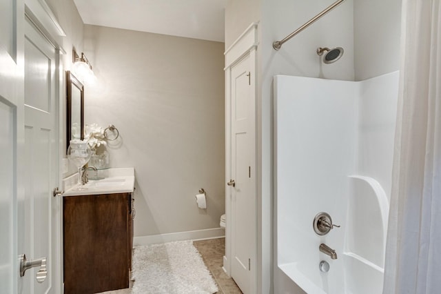 bathroom featuring baseboards, toilet, tile patterned flooring, tub / shower combination, and vanity