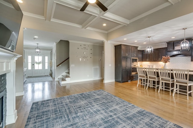 interior space with dark brown cabinetry, visible vents, coffered ceiling, appliances with stainless steel finishes, and beam ceiling