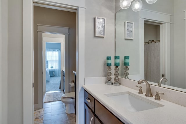 bathroom featuring vanity, toilet, and tile patterned floors