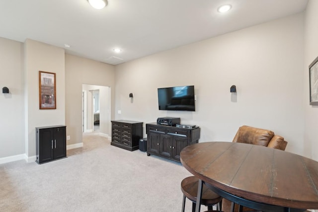 living room featuring light carpet, baseboards, and recessed lighting