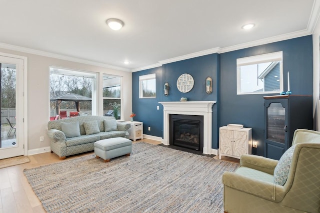 living room featuring baseboards, a fireplace with flush hearth, ornamental molding, wood finished floors, and recessed lighting