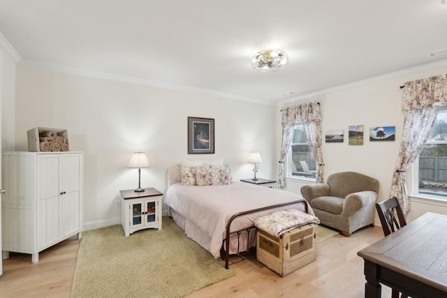 bedroom with ornamental molding, baseboards, and light wood finished floors