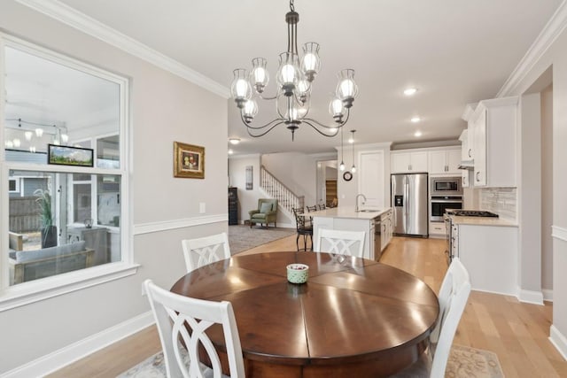 dining room featuring recessed lighting, baseboards, light wood-style floors, ornamental molding, and stairway