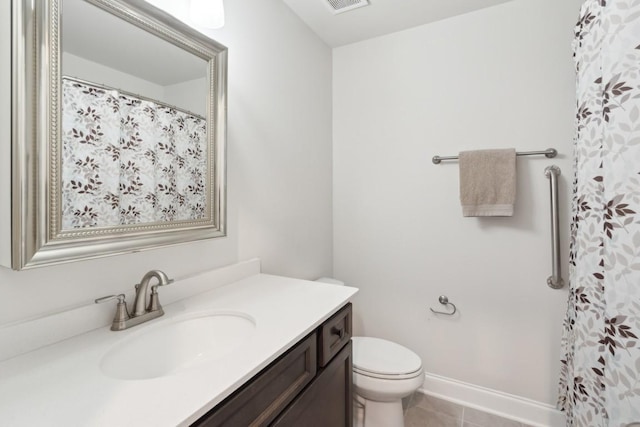 bathroom featuring visible vents, toilet, vanity, baseboards, and tile patterned floors