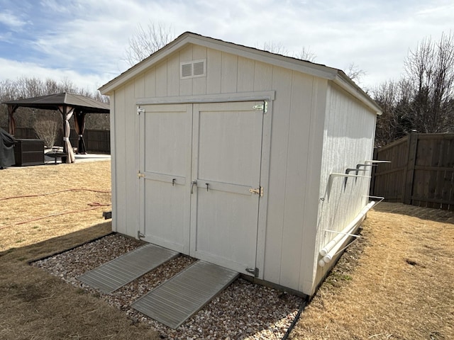 view of shed featuring a gazebo and fence