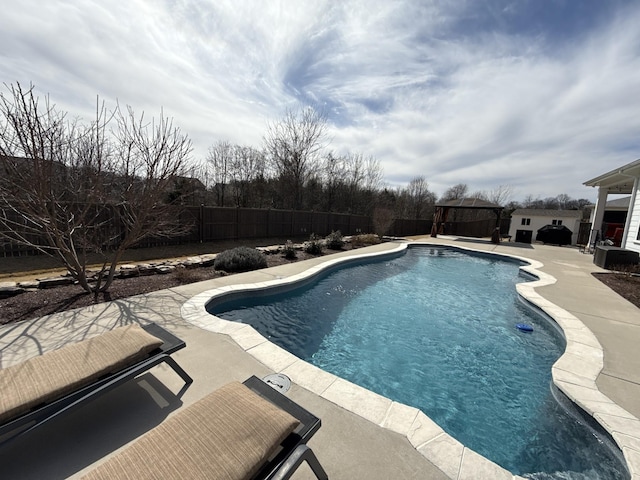 view of swimming pool with a patio area, a fenced backyard, a fenced in pool, and a gazebo