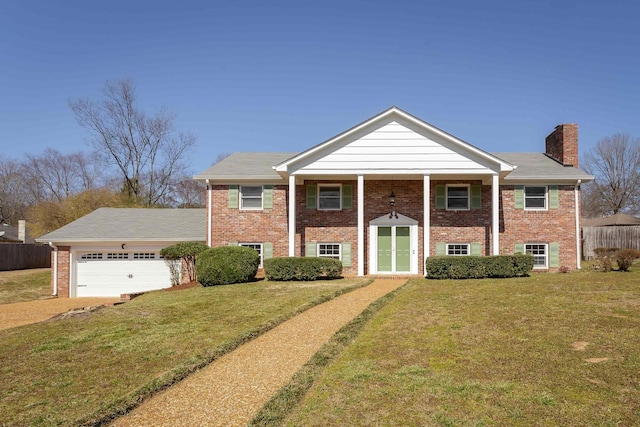 view of front of property featuring a garage, brick siding, a chimney, and a front lawn