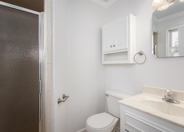 bathroom with ornamental molding, toilet, a shower stall, and vanity