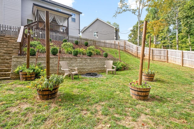 view of yard featuring stairway and a fenced backyard