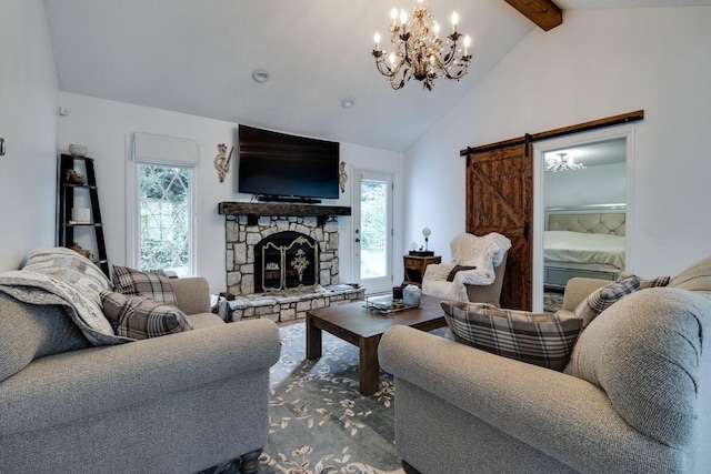 living area featuring a healthy amount of sunlight, a barn door, beam ceiling, and a stone fireplace