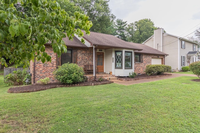 ranch-style home with brick siding, an attached garage, and a front yard