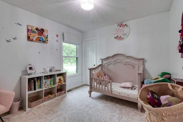 carpeted bedroom featuring a textured ceiling