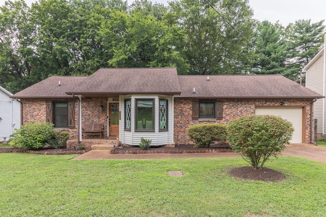 ranch-style house featuring a garage, roof with shingles, a front lawn, and brick siding