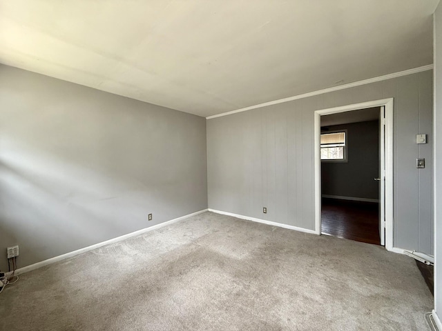 unfurnished room with carpet floors, baseboards, and ornamental molding