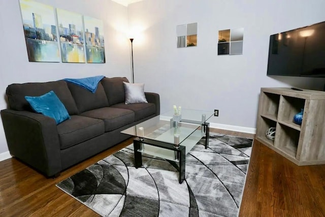 living room featuring wood finished floors and baseboards