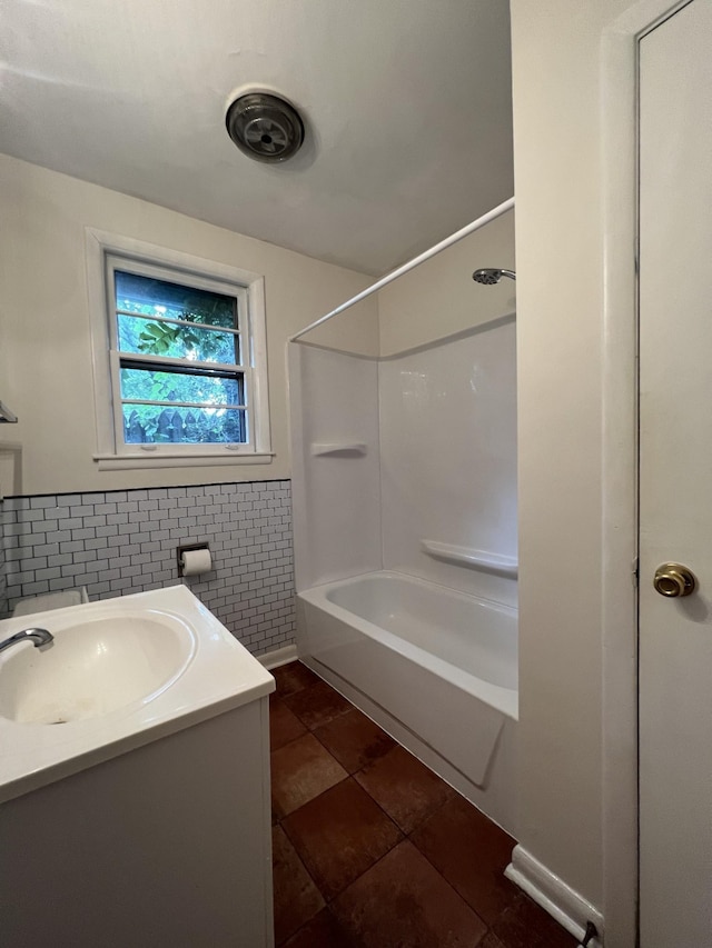 full bath with tile patterned flooring, a wainscoted wall, shower / bath combination, vanity, and tile walls