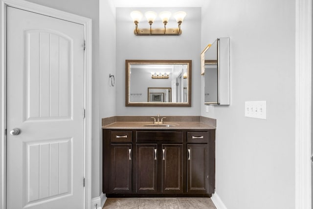 bathroom featuring baseboards and vanity