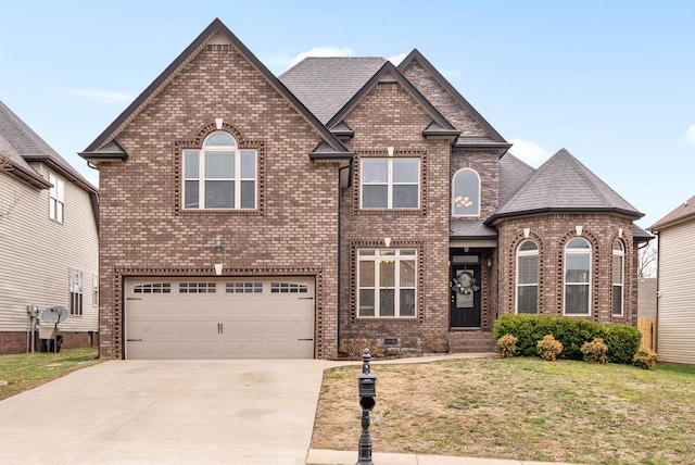 view of front of house with driveway, a shingled roof, an attached garage, a front lawn, and brick siding