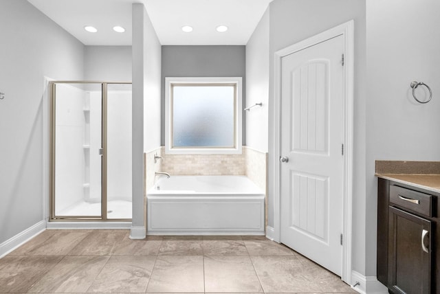 full bath featuring a stall shower, a garden tub, vanity, and recessed lighting