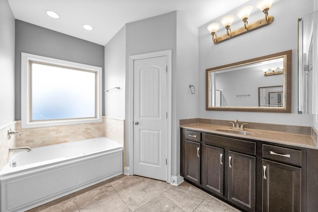 full bathroom featuring vanity, a bath, and recessed lighting