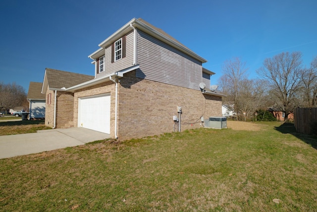 view of side of home with concrete driveway, an attached garage, fence, a yard, and brick siding