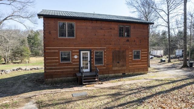 exterior space with crawl space and metal roof