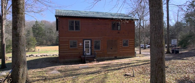 view of front facade featuring entry steps, metal roof, and crawl space