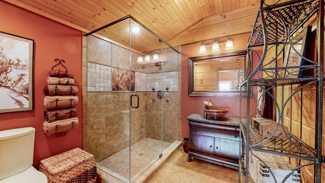 full bathroom featuring lofted ceiling, toilet, a shower stall, wooden ceiling, and tile patterned floors