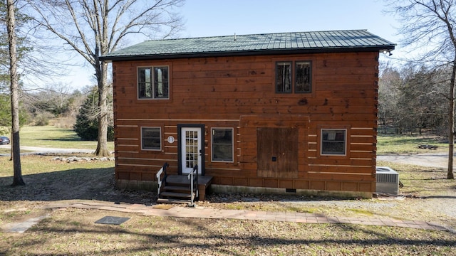 view of front of home with metal roof, central AC, crawl space, and entry steps