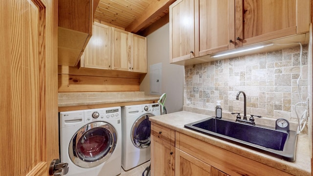 laundry area featuring wood ceiling, separate washer and dryer, a sink, and cabinet space