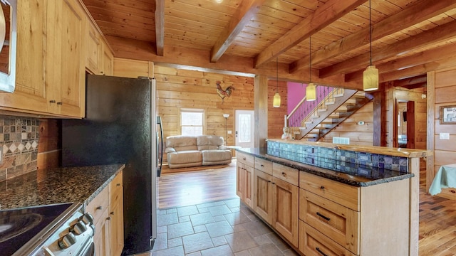 kitchen featuring wooden walls, stainless steel appliances, wood ceiling, open floor plan, and backsplash