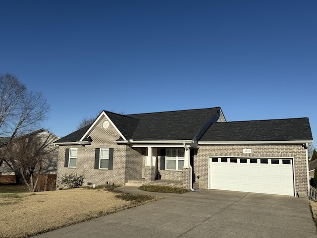 ranch-style house with driveway, brick siding, and an attached garage