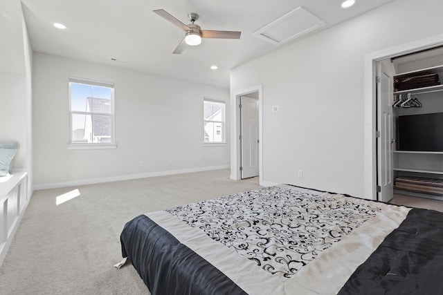 bedroom featuring light carpet, attic access, baseboards, a spacious closet, and recessed lighting