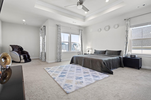 bedroom with carpet floors, a raised ceiling, visible vents, and baseboards