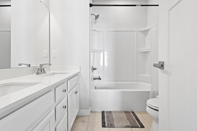 bathroom featuring toilet, a sink, shower / bathing tub combination, tile patterned floors, and double vanity