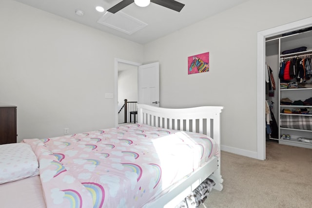 bedroom featuring ceiling fan, carpet flooring, a closet, a walk in closet, and attic access