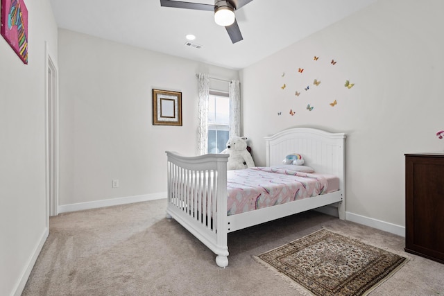 carpeted bedroom with visible vents, ceiling fan, and baseboards