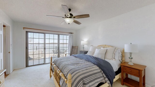 bedroom featuring ceiling fan, access to outside, a textured ceiling, and light colored carpet