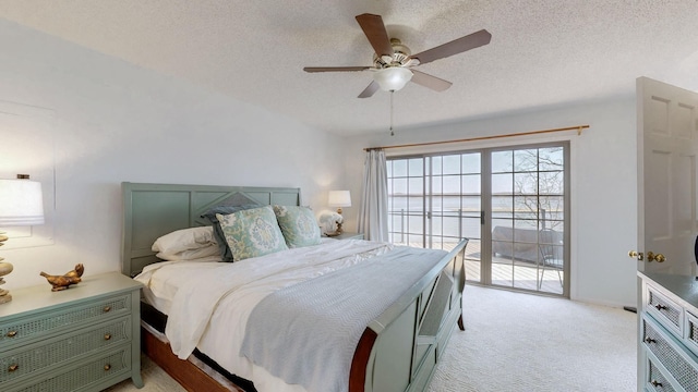 bedroom with access to exterior, light colored carpet, a textured ceiling, and a ceiling fan