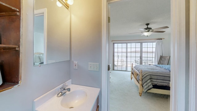 bathroom featuring a ceiling fan and vanity