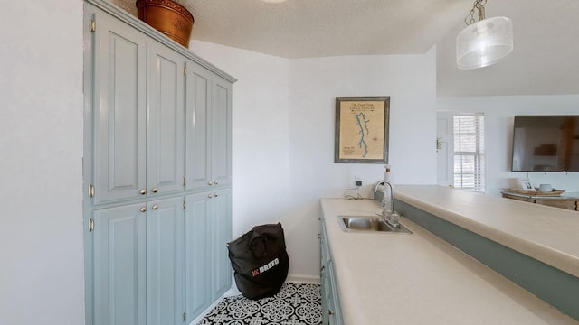 bathroom featuring a sink and a textured ceiling